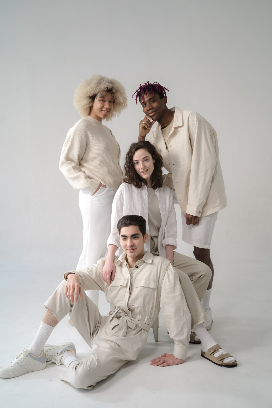 Men and Women in Beige and White Outfits