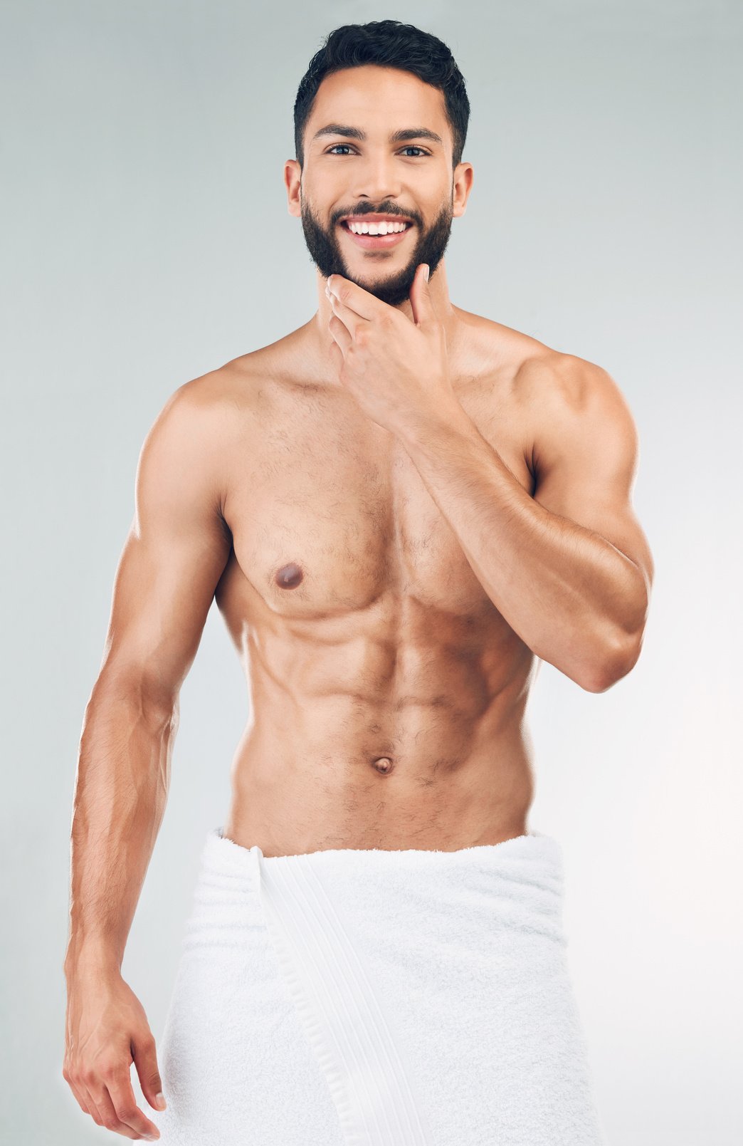 Skincare, Beauty and Portrait of Man with Towel in Studio on White Background. Wellness, Body Care and Male Model Pose for for Facial Cleanse, Skincare Products and Hygiene for Washing and Cleaning